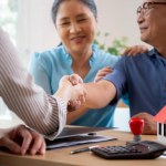 Happy couple elderly handshake with mortgage officer with agreement approve of buying home with loan, senior talking with agent real estate for planning while shaking hands, business and rent concept.