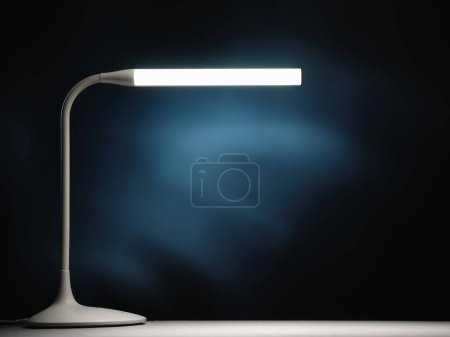 Foto de Lamp on the table and blue glow - Imagen libre de derechos