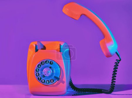 Photo for Vintage orange phone in neon light - Royalty Free Image