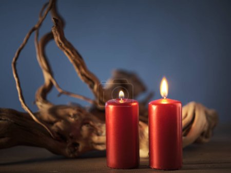 Photo for Red candles, driftwood, serene ambiance - Royalty Free Image