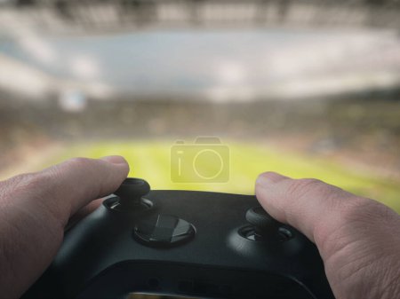Gaming Controller in Hands with Stadium Background