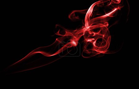 Red Smoke Swirling Against a Black Background
