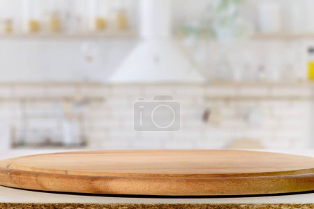Photo for Circular Wooden Cutting Board on Kitchen Countertop on blurred background - Royalty Free Image