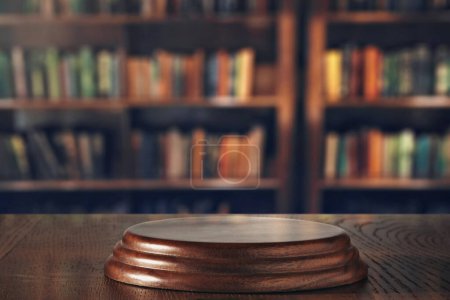 Photo for Wooden stand in front of blurred library shelves - Royalty Free Image