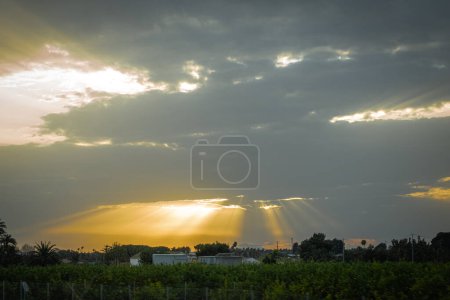 Photo for Reflections of sun rays between clouds. - Royalty Free Image