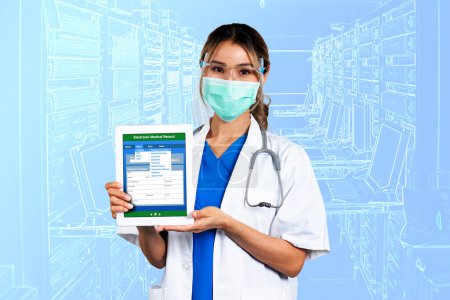 Photo for Front view and half body photo of female doctor holding digital tablet showing electronic medical record form on screen with blue background. - Royalty Free Image