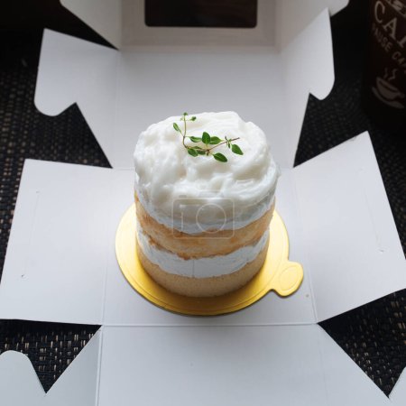 Photo for Coconut cake looks delicious placed on cardboard box ready to sending to customer. - Royalty Free Image