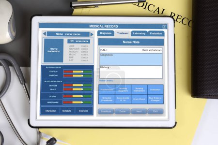 Photo for Top view of doctor desk there is electronic tablet showing blank medical record form screen - Royalty Free Image