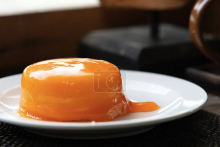 Photo for Close up of a piece of homemade orange cake served on white porcelain plate. - Royalty Free Image