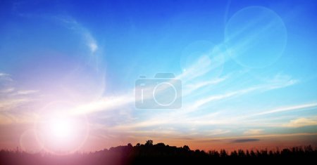 Photo for Shadows of forests and hills under bright blue skies and white clouds as the sun beams shine. - Royalty Free Image