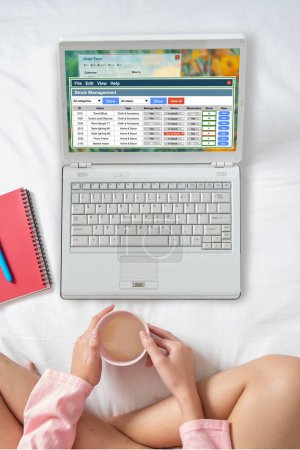 Photo for Young woman sit comfortably on bed to work from home by using laptop computer and internet communication. - Royalty Free Image