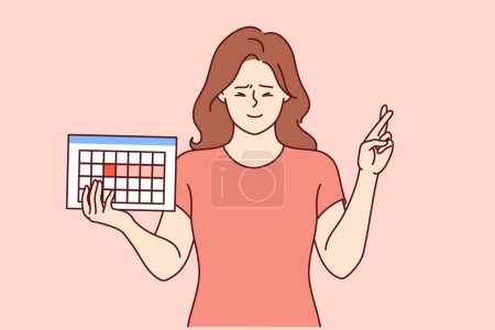 Female hormonal calendar in hands girl crossing fingers in hope of successfully conceiving child. Hormonal calendar for tracking menstrual cycles and genetic needs for women wishing to become pregnant