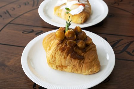 Photo for Macadamia croissants on a wooden table - Royalty Free Image