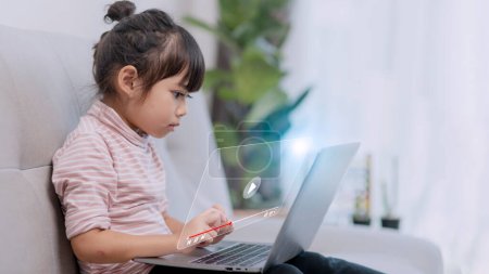 Photo for Asian little girl using the laptop. Internet of Things. EdTech. - Royalty Free Image