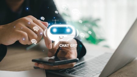 Foto de ChatGPT Chat with AI or Artificial Intelligence. man chatting with a smart AI or artificial intelligence using an artificial intelligence chatbot developed by OpenAI. - Imagen libre de derechos