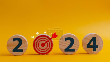 Photo for 2024 goals of business or life. Wooden circles with 2024 and goal icons. Starting to new year. Business common goals for planning new projects, annual plans, business target achievement - Royalty Free Image