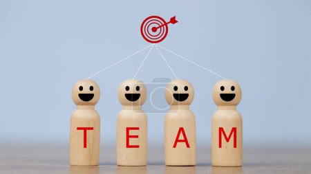 Photo for Wooden figures smile faces with team wording on the body and target icons. Teamwork and Ideas for business corporation concept. Business target and team concept. - Royalty Free Image