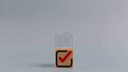 Photo for Wooden cube with a checkmark icon. Goals achievement and business success. Task completion. Ethical corporate. Do the right thing. Quality and ISO symbol. - Royalty Free Image