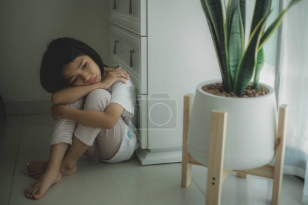 Photo for Lonely little sitting at home alone, upset unhappy child waiting for parents, thinking about problems, bad relationship in family, psychological trauma - Royalty Free Image