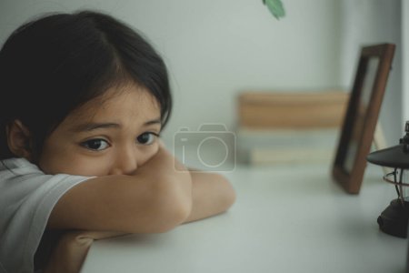 Photo for Lonely little sitting at home alone, upset unhappy child waiting for parents, thinking about problems, bad relationship in family, psychological trauma - Royalty Free Image