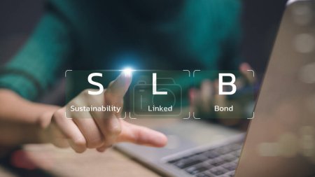 A person is pointing at a laptop screen that says SLB. Concept of sustainability and linked bonds