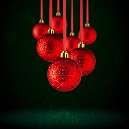 Red Christmas tree ornaments hanging with copy space. Christmas Balls made of glass or plastic hanging over abstract dark green background.