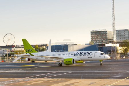 Photo for Airbaltic commercial aircraft on runway at the airport in Tallinn, Estonia. Tallinn, Estonia - May, 2021. - Royalty Free Image