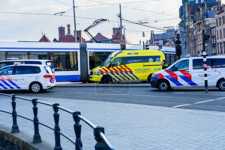 Photo for Emergency situation in Amsterdam city center as a pedestrian or cyclist has been hit. The ambulances and police vehicles are on the scene to provide assistance. - Royalty Free Image