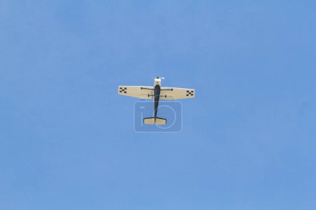 Single engine plane flying with a beautiful blue sky in Rio de Janeiro, Brazil.