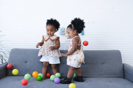 Foto de Niñas afroamericanas con globos en casa - Imagen libre de derechos