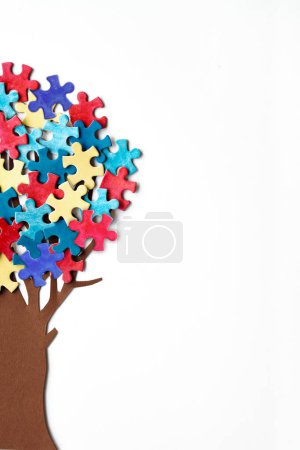 Photo for Abstract tree with colorful vibrant puzzle pieces on off white background. Autism Awareness Day, World Autism Day decorative element. Border for leaflets, cards. Creative background with copy-space. - Royalty Free Image