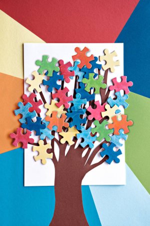 Photo for Abstract tree with colorful vibrant puzzle pieces on off white background. Autism Awareness Day, World Autism Day decorative element for banner, wallpaper. Paper art arrangement, creative background for flyer or poster. - Royalty Free Image