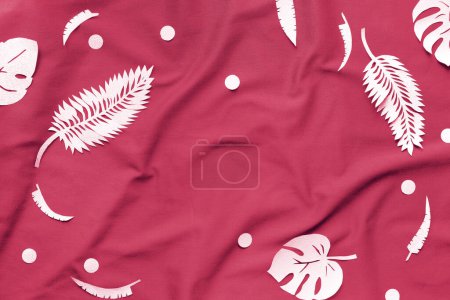 Photo for Viva Magenta color of the year 2023. Creative trendy flat lay with exotic paper leaves, monstera and fern, on magenta textile. Top view. Flat lay. Copy space. Minimal creative paper craft decor. - Royalty Free Image