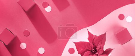 Photo for Cyan and red Christmas panoramic background.Top view, creative flat lay with Xmas decorations. Poinsettia flower, gift boxes and paper circles, confetti on abstract two tone background - Royalty Free Image