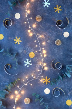 Photo for Handmade DIY Christmas or New Year decorations from cardboard. Top view, flat lay with lights on Xmas garland, golden paper balls, snowflakes, eucalyptus. Merry Christmas, Happy New Year background. - Royalty Free Image