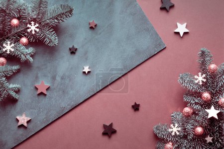 Photo for Christmas flat lay with winter decorations. Wooden stars, paper snowflakes and Xmas light garland. Decorated fir twigs on split dark chestnut brown, blue grey textured background. Self made diy decor. - Royalty Free Image