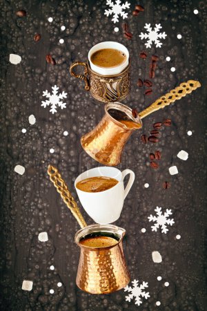 Photo for Balancing pyramid of jezves, turkish coffee pots and cups on dark grey with coffee beans and navat sugar on dark textured background. - Royalty Free Image