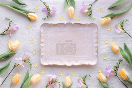 Foto de Natural Easter decor, overhead, flat lay with quail eggs, feather wreath, yellow tulip flowers on off white textile background. Flat lay, top view natural low impact springtime background, copy-space - Imagen libre de derechos