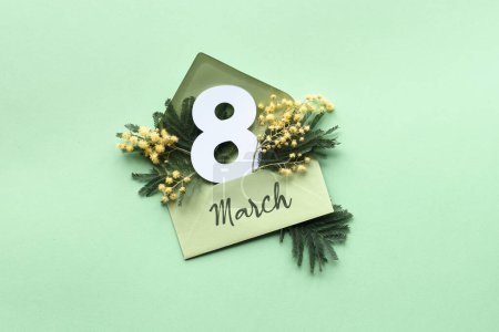 Foto de Número 8 en sobre de papel con flores frescas de mimosa, símbolo de la primavera. Día Internacional de la Mujer saludo plano sobre papel verde menta, diseño de papel pintado. - Imagen libre de derechos