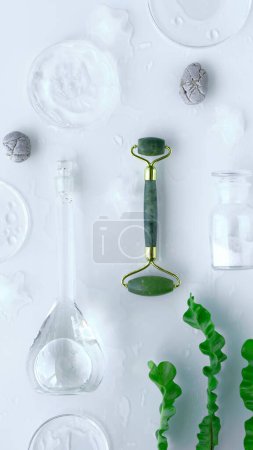 Photo for Jade massage roller, moisturizer in glass petri dish, various glass objects, stones and exotic leaves on off white background. Face care routine. - Royalty Free Image