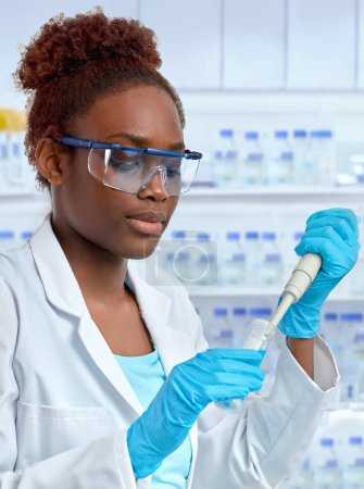 Photo for African female scientist or graduate student in lab coat and protective wear works in modern laboratory - Royalty Free Image