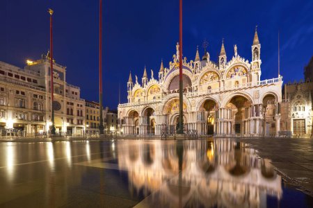 Foto de Basílica en la plaza de San Marco de Venecia con reflexión aqua alta al atardecer. - Imagen libre de derechos
