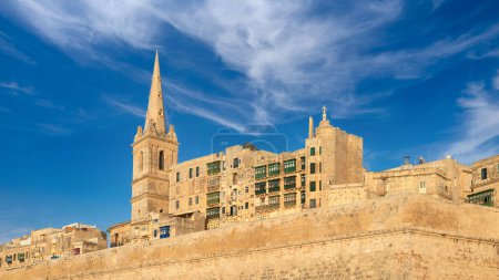Photo for An old sandstone church and houses in Valetta, Malta, on a bright day - Royalty Free Image