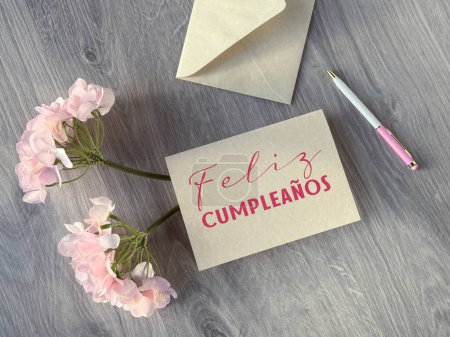 Photo for A card with the Spanish phrase Feliz Cumpleanos that means Happy Birthday. - Royalty Free Image