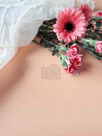 Photo for A pink flower is lying gracefully below crumpled off white scarf, creating a soft and soothing contrast between the delicate petals and the clean fabric. - Royalty Free Image