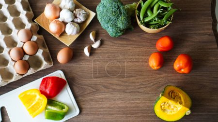 Photo for Flay lay food cooking vegetable broccoli egg pepper pea garlic background on wood texture text copy space - Royalty Free Image