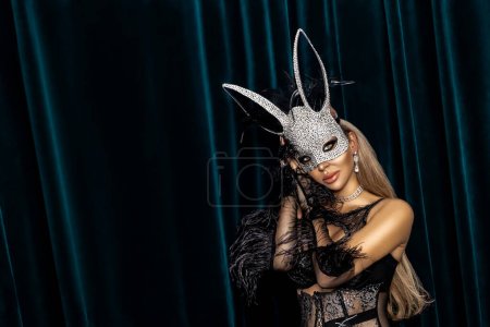 Photo for Sexy blonde woman dressed in Easter bunny mask and sexy lace lingerie and sensually posing on dark velvet background. Easter bunny costume - Image. - Royalty Free Image