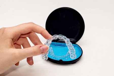Photo for Transparent aligners and storage case box. Invisible braces. Clear teeth straighteners. Plastic bracers - Royalty Free Image