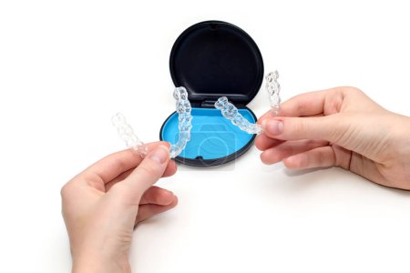Photo for Transparent aligners and storage case box. Invisible braces. Clear teeth straighteners. Plastic bracers - Royalty Free Image