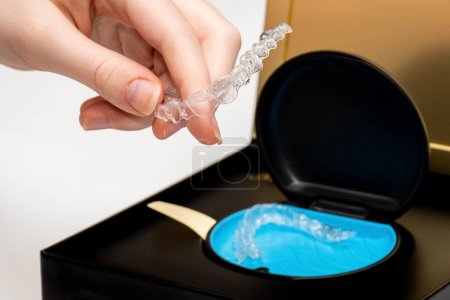 Photo for Transparent aligners in a box. Invisible braces. Clear teeth straighteners. Clear plastic bracers - Royalty Free Image